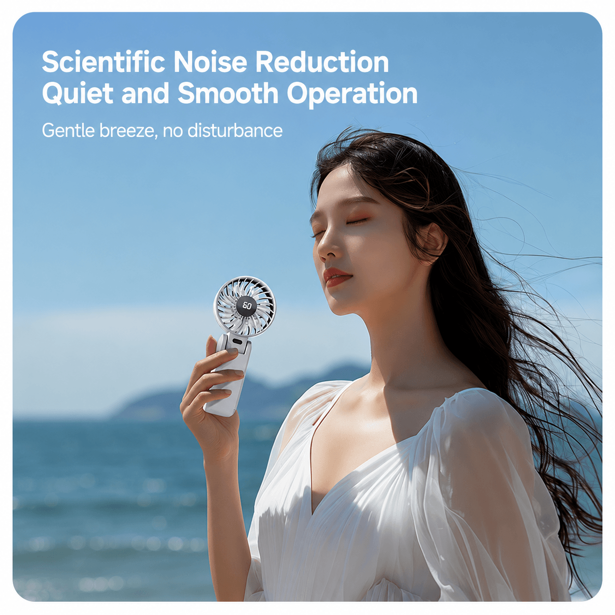 A white mini handheld fan,  scientific noise reduction.